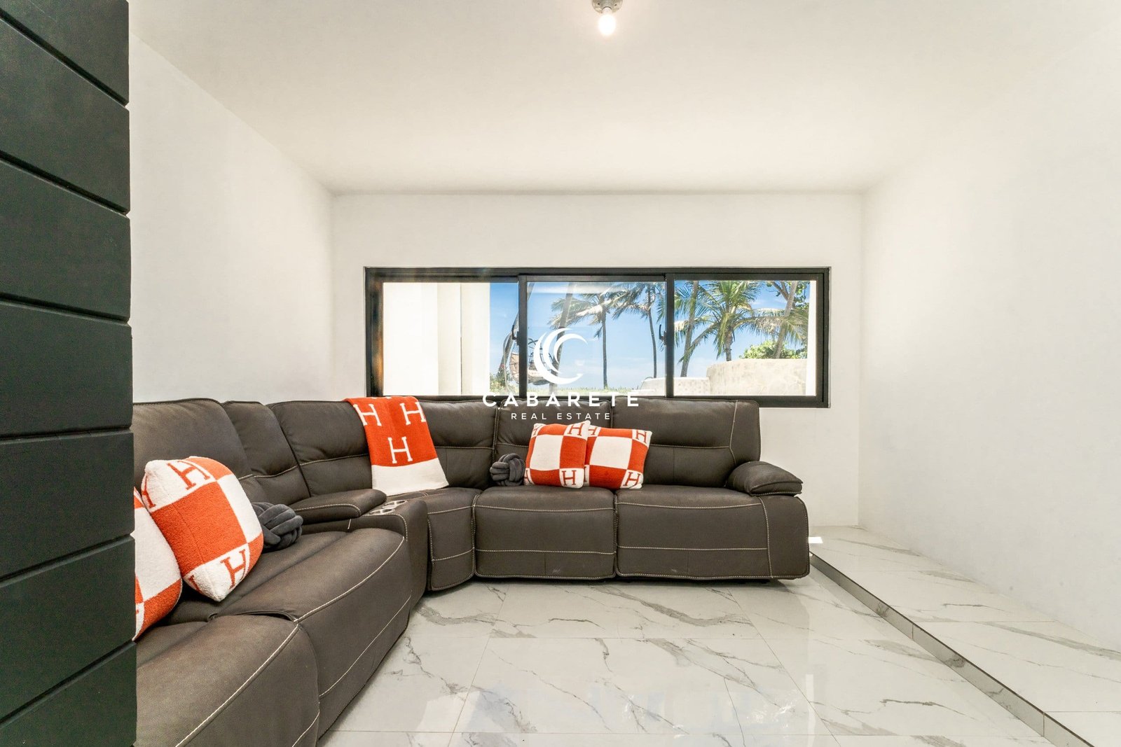 4 Bedroom Villa For Sale Cabarete East living Room3 Salon de bord de mer à vendre à Cabarete, Puerto Plata, avec de grandes baies vitrées et une vue imprenable sur l'océan.